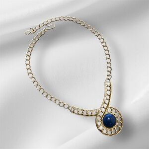 A vintage Monet Elegant Gold tone with a navy Blue stone Pendant Necklace